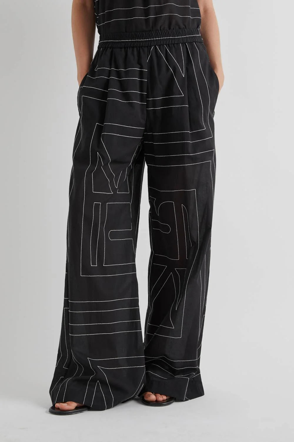 MEIMEIJ Trousers with All-Over Logo Embroidery